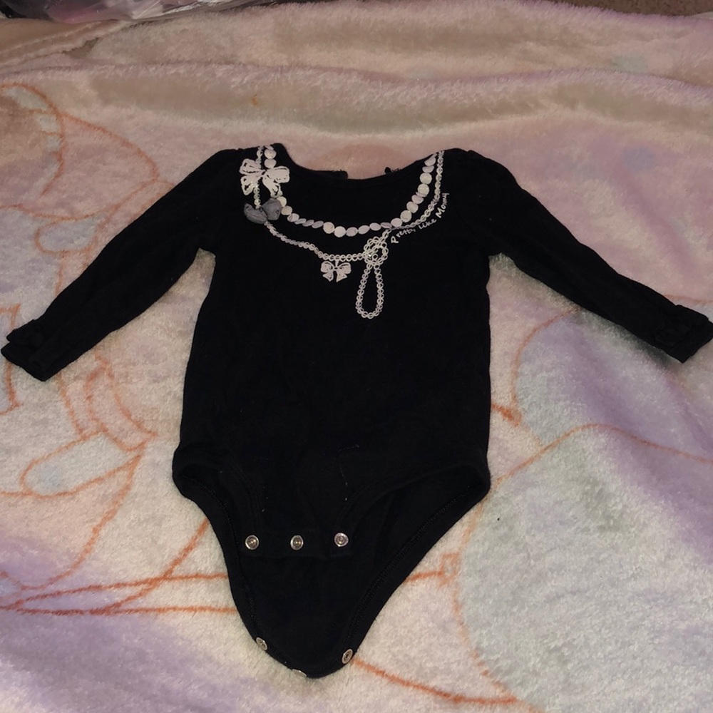 A black onesie with necklace print